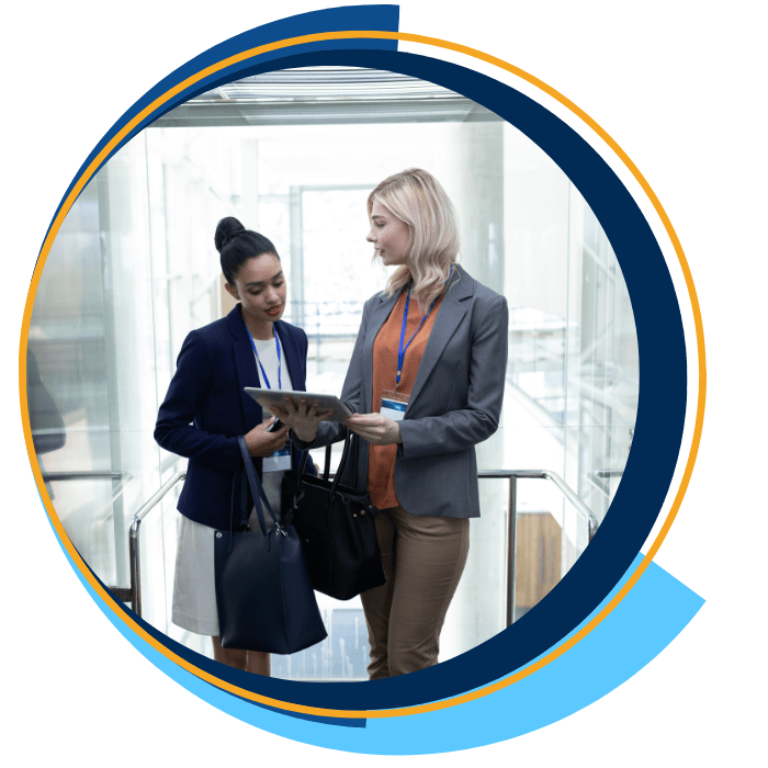 Multi-ethnic businesswomen discussing over digital tablet in office elevator